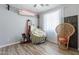 Bedroom with unique decor, including a peacock chair and rocking horse at 14760 W Riviera Dr, Surprise, AZ 85379