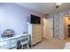 Bright bedroom featuring a desk, dresser, and floral wallpaper at 14760 W Riviera Dr, Surprise, AZ 85379