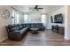 Open living space featuring a large sectional sofa and hardwood floors at 14760 W Riviera Dr, Surprise, AZ 85379
