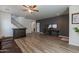 Living room with hardwood floors, a dark accent wall, and staircase at 14760 W Riviera Dr, Surprise, AZ 85379