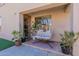 Inviting patio with hanging chair and potted plants at 14760 W Riviera Dr, Surprise, AZ 85379