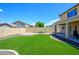 Landscaped backyard with artificial turf and sitting area at 1860 W Buckhorn Trl, Phoenix, AZ 85085