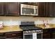 Close-up view of a kitchen with stainless steel appliances and granite countertops at 1860 W Buckhorn Trl, Phoenix, AZ 85085