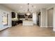 Open concept kitchen with island, dark cabinets and chandelier lighting at 1860 W Buckhorn Trl, Phoenix, AZ 85085