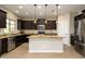 Modern kitchen with dark cabinetry, granite island, and stainless steel appliances at 1860 W Buckhorn Trl, Phoenix, AZ 85085