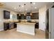 Modern kitchen with dark cabinetry, granite island, and stainless steel appliances at 1860 W Buckhorn Trl, Phoenix, AZ 85085