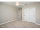 Bedroom with ceiling fan, carpet, and double doors closet at 1860 W Buckhorn Trl, Phoenix, AZ 85085