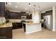 Modern kitchen with dark wood cabinets, granite counters, and island at 1860 W Buckhorn Trl, Phoenix, AZ 85085