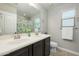 Clean bathroom with double vanity and shower/tub combo at 1860 W Buckhorn Trl, Phoenix, AZ 85085