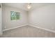 Bright bedroom with neutral walls, carpet flooring, and ceiling fan at 1860 W Buckhorn Trl, Phoenix, AZ 85085
