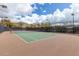 Well-maintained tennis court with brown and green surface at 1860 W Buckhorn Trl, Phoenix, AZ 85085