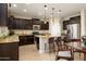Modern kitchen with dark cabinets, granite countertops, and stainless steel appliances at 1860 W Buckhorn Trl, Phoenix, AZ 85085