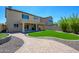 Landscaped backyard with artificial turf and a covered patio at 1860 W Buckhorn Trl, Phoenix, AZ 85085