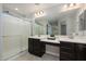 Elegant bathroom with double vanity, large mirror, and shower at 1860 W Buckhorn Trl, Phoenix, AZ 85085