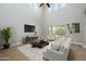 Spacious living room with high ceilings, large windows, and a neutral color palette at 1860 W Buckhorn Trl, Phoenix, AZ 85085