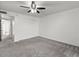 Spacious bedroom with ceiling fan and gray carpeting at 2501 E Pepper Ridge Cir, Phoenix, AZ 85032