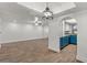 Open dining room with wood-look tile floor and pendant lighting at 2501 E Pepper Ridge Cir, Phoenix, AZ 85032