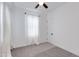 Spacious bedroom featuring a ceiling fan and large window with sheer curtains at 18888 E Apricot Ln, Queen Creek, AZ 85142