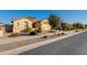 Street view of a neighborhood with similar homes and landscaping at 18888 E Apricot Ln, Queen Creek, AZ 85142