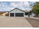 House exterior featuring a three-car garage and driveway at 2930 E Leland St, Mesa, AZ 85213