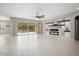 Living room with fireplace, built-in shelving, and backyard access at 19039 N 264Th Ave, Buckeye, AZ 85396