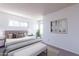 Spacious bedroom with a large bed, bench, and two windows at 1023 E Escuda Dr, Phoenix, AZ 85024
