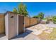 Tan storage shed in the backyard next to a hot tub at 1023 E Escuda Dr, Phoenix, AZ 85024