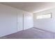 Bright bedroom with neutral carpeting and large window at 1023 E Escuda Dr, Phoenix, AZ 85024
