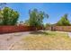 Landscaped backyard with a shed and a wooden fence at 1023 E Escuda Dr, Phoenix, AZ 85024
