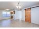Dining area with barn door and view into kitchen at 1023 E Escuda Dr, Phoenix, AZ 85024