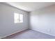 Well-lit bedroom featuring a window with a view and neutral carpet at 1023 E Escuda Dr, Phoenix, AZ 85024