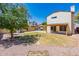 Backyard with a large grassy area, gravel, and a tree at 1023 E Escuda Dr, Phoenix, AZ 85024