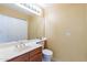 Clean bathroom with single sink vanity, toilet, and mirrored medicine cabinet at 1023 E Escuda Dr, Phoenix, AZ 85024