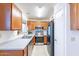 Kitchen features wood cabinets and stainless steel appliances at 1023 E Escuda Dr, Phoenix, AZ 85024