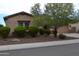 Tan house with stone accents and lush landscaping at 3026 E Longhorn Dr, Gilbert, AZ 85297