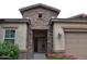 Front entrance with stone accents and bougainvillea at 3026 E Longhorn Dr, Gilbert, AZ 85297