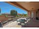 Spacious covered patio with multiple seating areas and views of the surrounding landscape at 21159 N Redington Point Dr, Surprise, AZ 85387