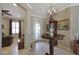 Bright and airy entryway with a charming table and grandfather clock at 21159 N Redington Point Dr, Surprise, AZ 85387