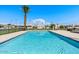 Community pool with palm trees and surrounding landscaping at 3345 E University Dr # 72, Mesa, AZ 85213