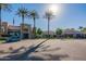 Front view of community clubhouse with parking and palm trees at 19661 N Echo Rim Dr, Surprise, AZ 85387