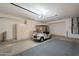 Garage with golf cart, storage cabinets, and epoxy flooring at 19661 N Echo Rim Dr, Surprise, AZ 85387