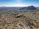 Bird's eye view of a sprawling estate, showcasing its expansive lot and desert landscape at 16229 N 115Th Pl, Scottsdale, AZ 85255