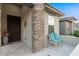 Elegant entryway with a decorative door, stone accents, and a sitting area at 20620 N Gardenia Rd, Maricopa, AZ 85138