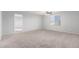 Carpeted bedroom with ceiling fan and access to another room at 10204 W Lawrence Ln, Peoria, AZ 85345