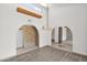 Dining area with wood-look flooring and arched doorways at 15234 N 19Th Pl, Phoenix, AZ 85022