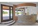 Wet bar with pool view, tile backsplash, and wood flooring at 15234 N 19Th Pl, Phoenix, AZ 85022