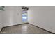 Small spare bedroom with tile floors and a window overlooking the pool at 15234 N 19Th Pl, Phoenix, AZ 85022