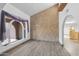 Dining room with arched window, textured wall, and wood-look flooring at 15234 N 19Th Pl, Phoenix, AZ 85022
