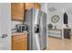 Kitchen boasts stainless steel refrigerator and ample cabinet storage at 259 W Satinka Dr, San Tan Valley, AZ 85140