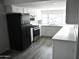 Bright kitchen with white cabinets, quartz countertops, and modern appliances at 17836 N 21St St, Phoenix, AZ 85022